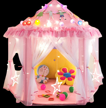 Pink children's play tent with lights and toys inside, on a light wooden floor.