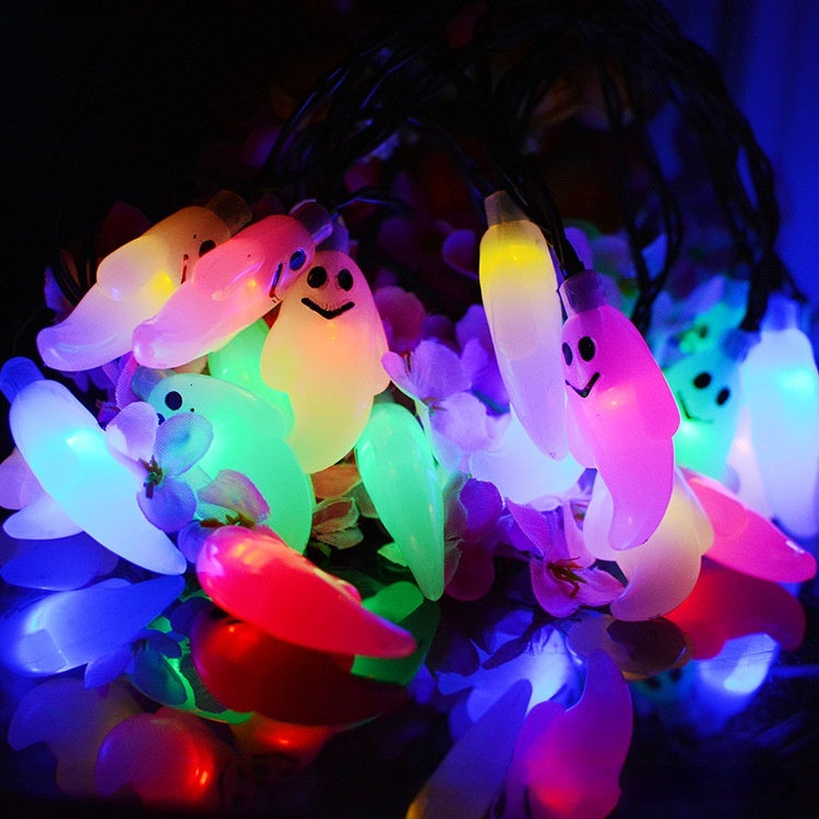 String lights with colorful ghost and candy corn designs on a dark background