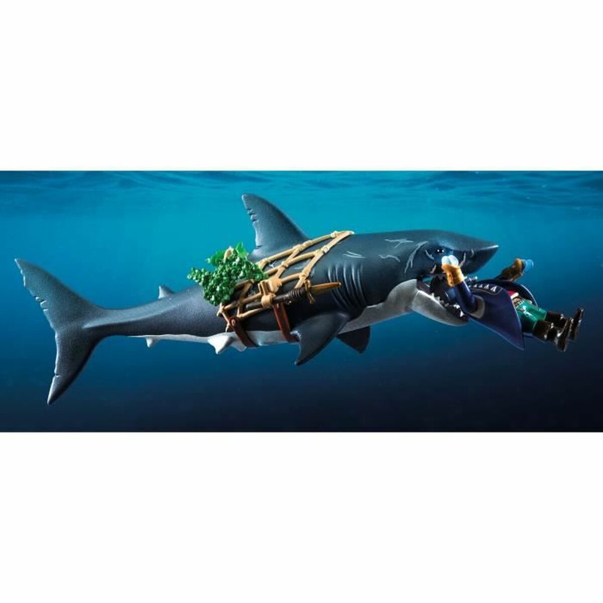 Toy shark with a diver attached underwater