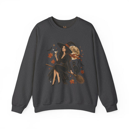 A dark gray crewneck sweatshirt featuring a detailed graphic of a witch sitting on a broomstick with a cat, surrounded by autumn leaves and a full moon.