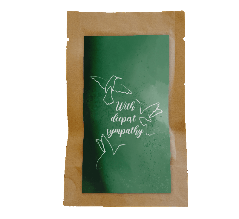 Green card with white dove design and text on a wooden surface