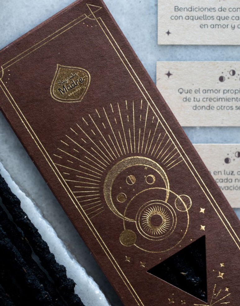 Brown book with gold embossed design on a textured surface
