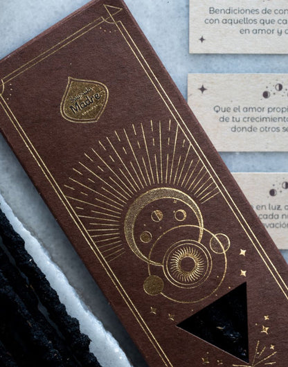 Brown book with gold embossed design on a textured surface