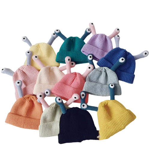 Colorful knit baby hats with toy arms and heads on a white background