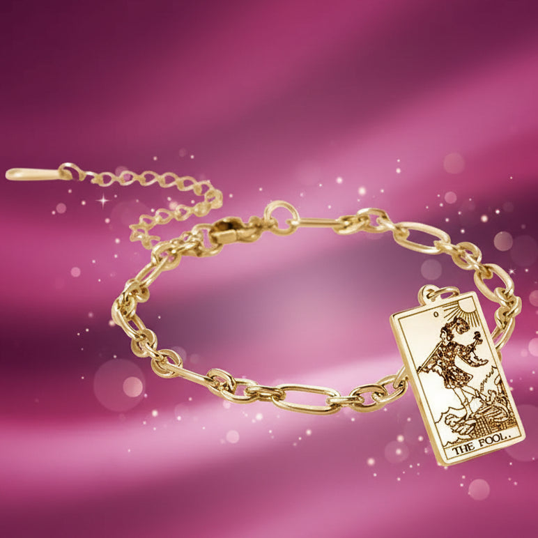 Gold bracelet with a tarot card charm on a white background