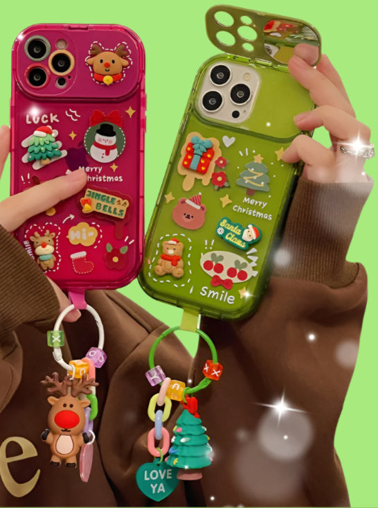 Two phone cases with Christmas designs held by a person wearing a brown sweater.