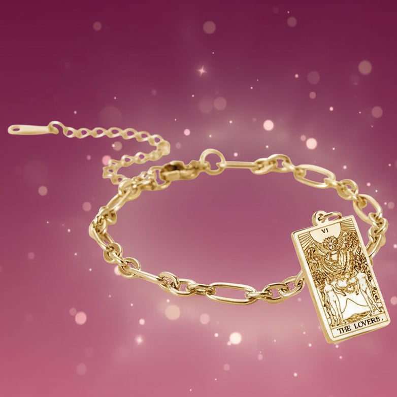 Gold bracelet with tarot card charm on a white background