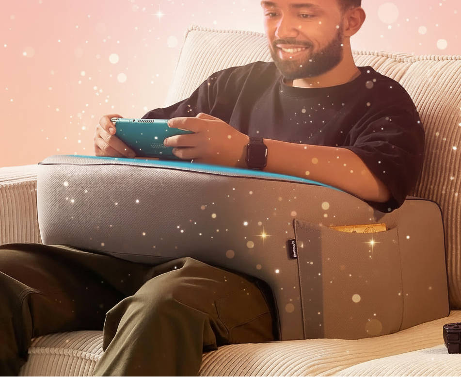 Man sitting on a couch using a tablet with a colorful background