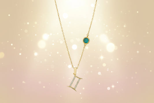 Gold necklace with gemstone pendant on a white background