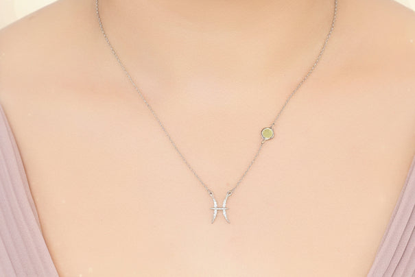 Necklace with a pendant worn by a person against a neutral background
