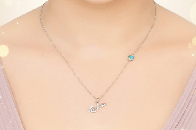 Necklace with a pendant worn by a person on a plain background