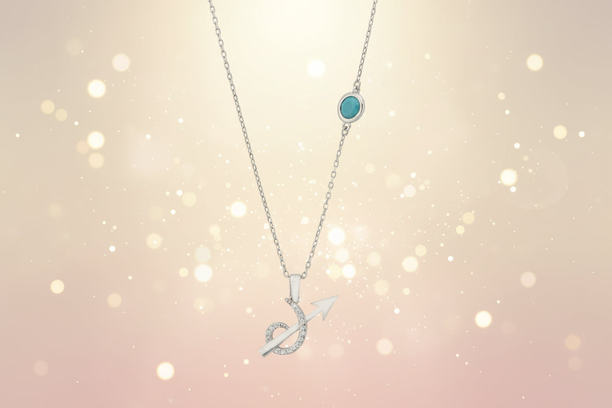 Silver necklace with a turquoise pendant and arrow design on a white background