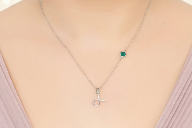 Necklace with a pendant worn by a person on a plain background