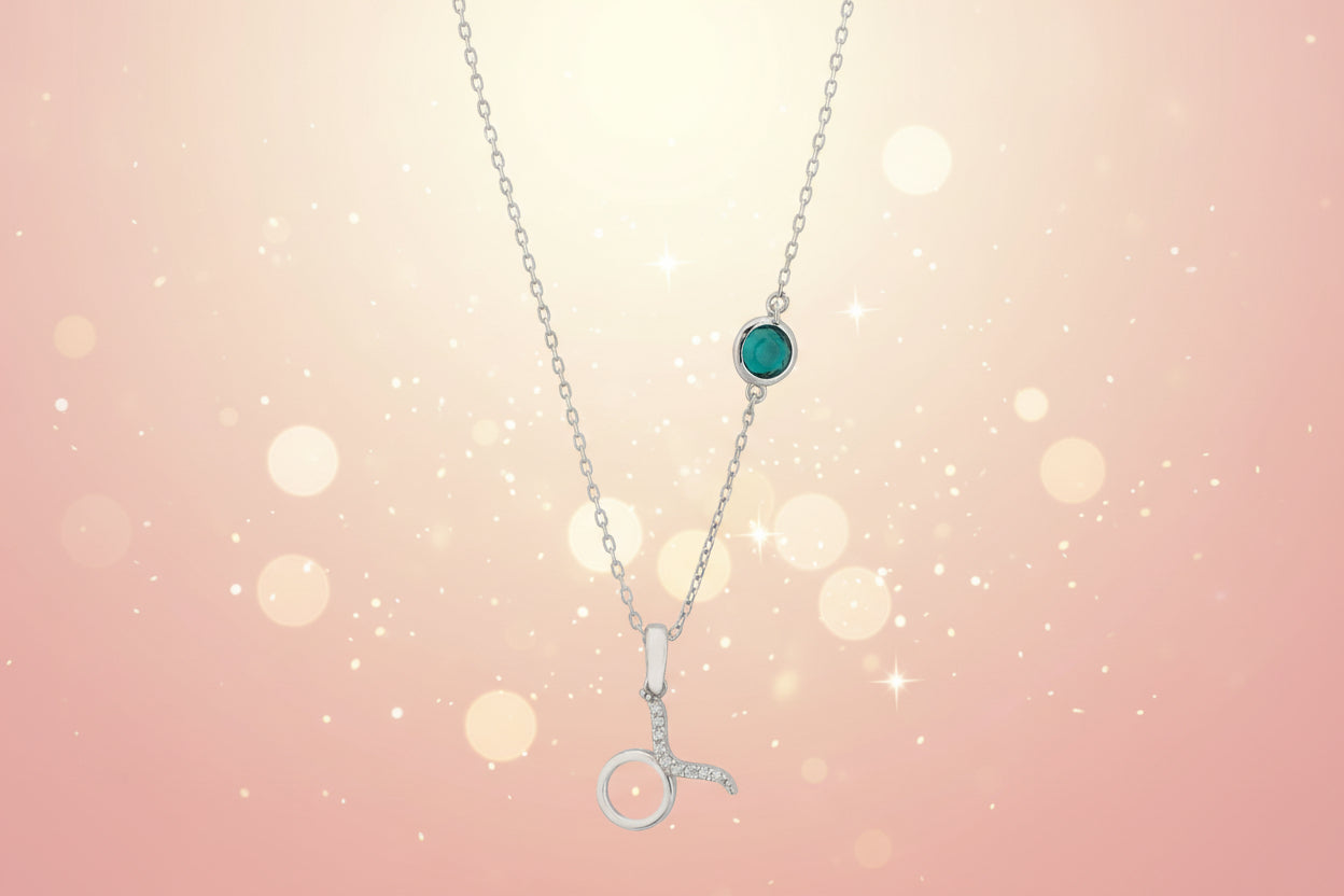 Necklace with a green gemstone and silver pendant on a white background