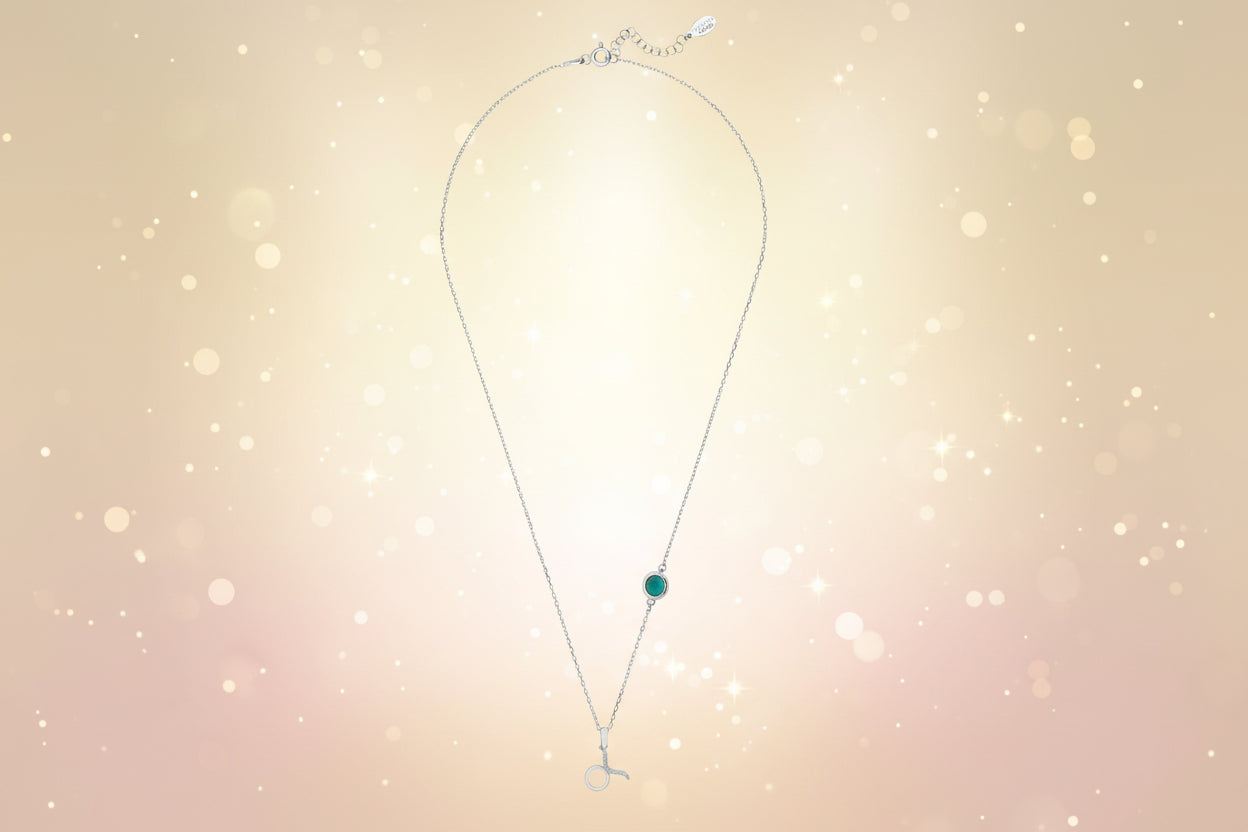 Necklace with a green gemstone on a white background