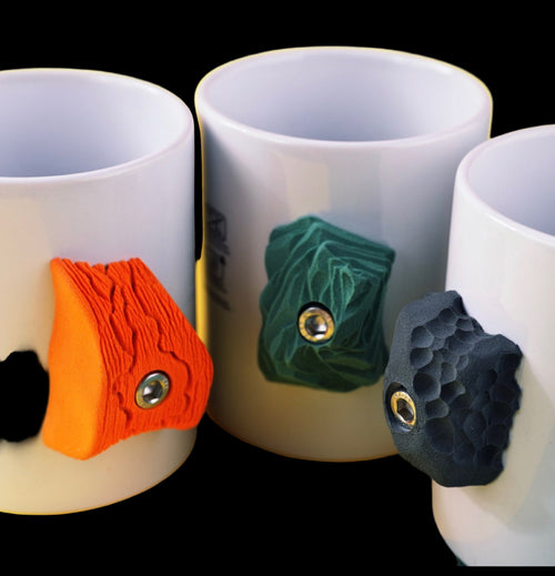 Three white mugs with colorful decorative elements on a yellow background