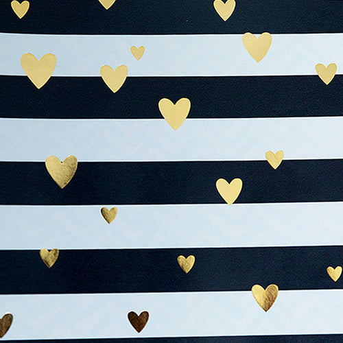 Pattern of gold hearts on black and white striped fabric