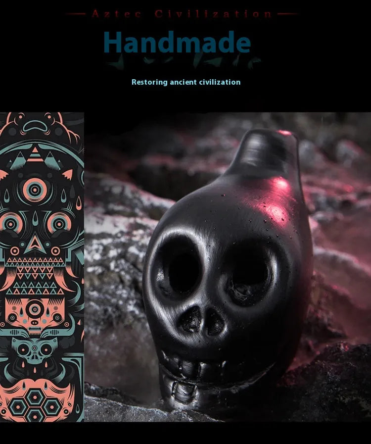 Black skull-like sculpture with red light on a dark background, next to a colorful geometric design.