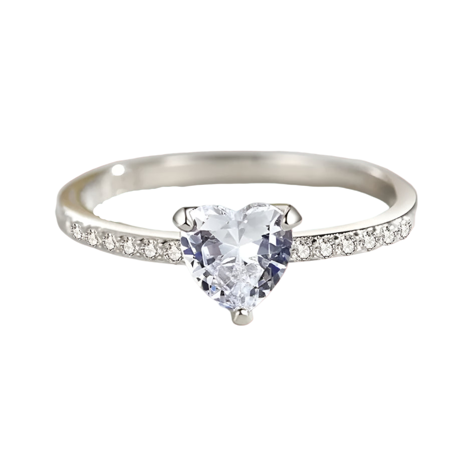 Silver ring with a heart-shaped gemstone on a light background