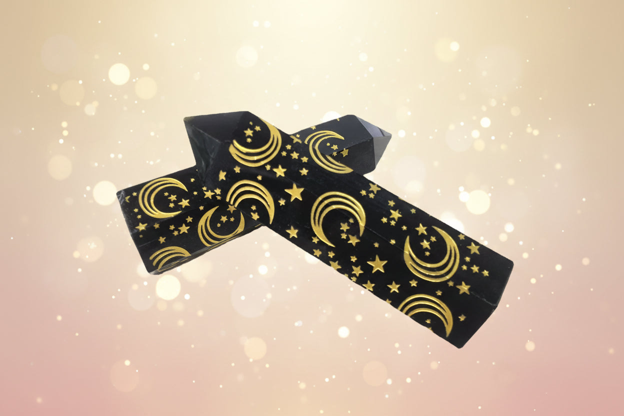 Black wristband with gold star and moon pattern on a white background