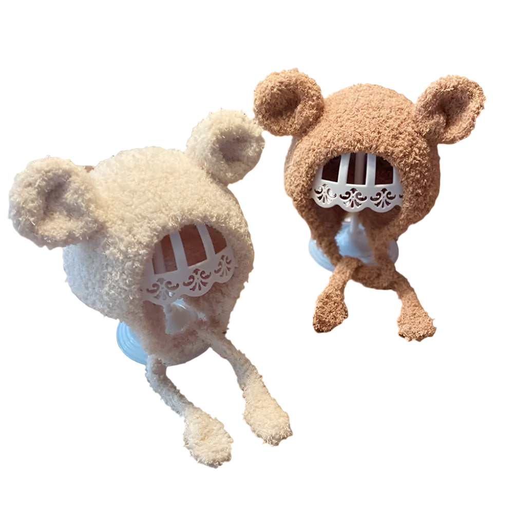 Two plush toys with bear-like designs on a wooden table.