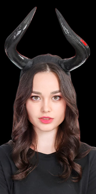 Person wearing black devil horns on a white background