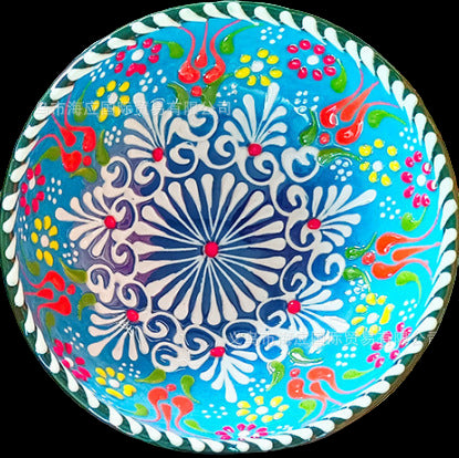 Decorative plate with colorful floral pattern on a textured surface