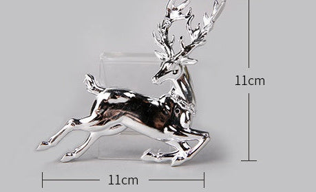 Metallic deer figurines in silver, gold, and clear with measurements on a gray background