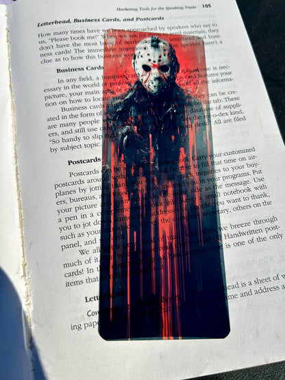 Halloween-themed bookmark with a ghostly figure on a book page
