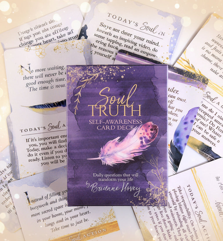 Purple card deck titled 'Soul Truth Self-Awareness Card Deck' with a feather design on a background of other cards.