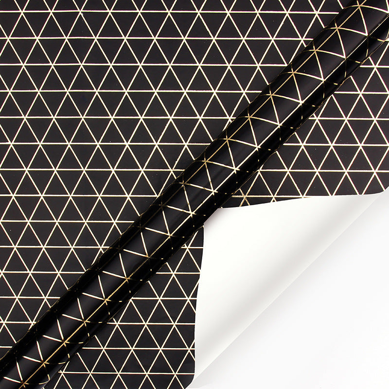 Black paper with gold geometric triangle pattern