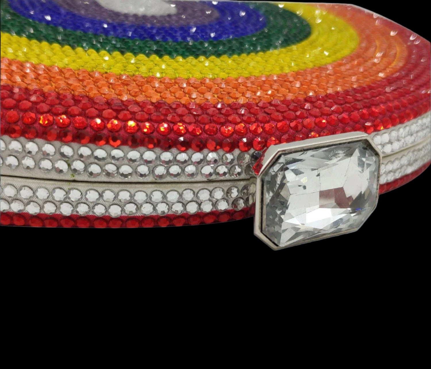 Colorful belt with rhinestones and a large crystal on a gray background