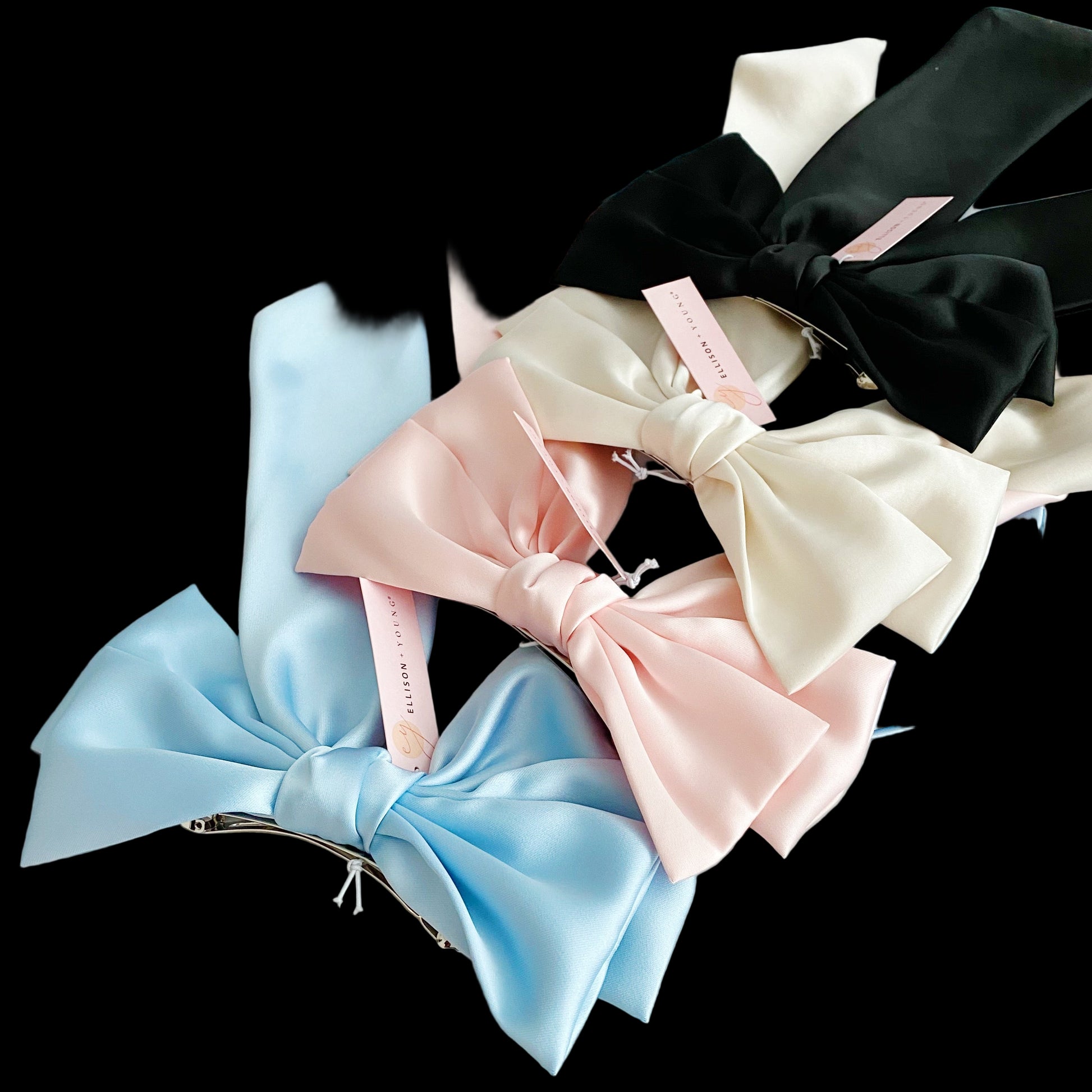 Set of colorful satin hair bows on a marble surface