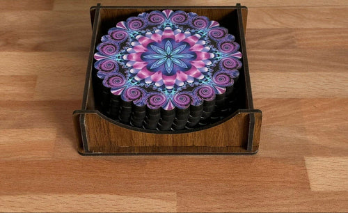 Decorative coaster with a colorful mandala design in a wooden holder on a wooden surface.