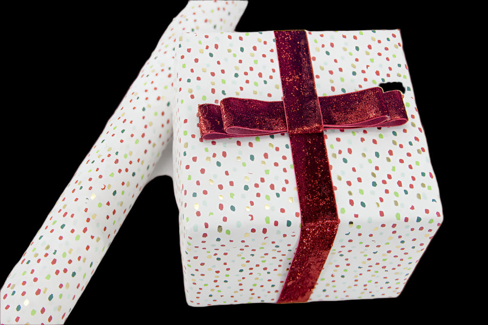 Gift box with polka dot pattern and red ribbon on a white background