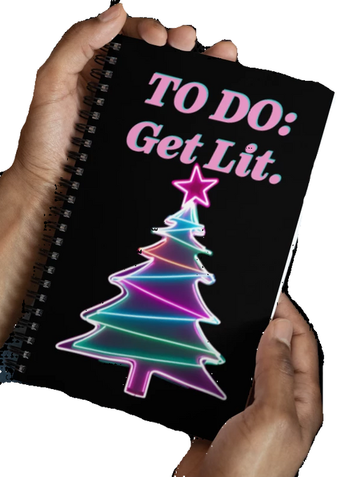 Notebook with a colorful Christmas tree design and text 'TO DO: Get Lit.' held by hands.