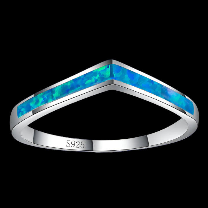 Silver ring with blue opal inlay on a white background