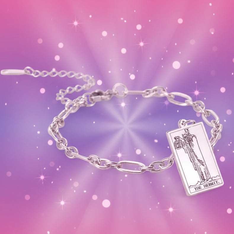 Silver chain bracelet with a tarot card charm on a white background