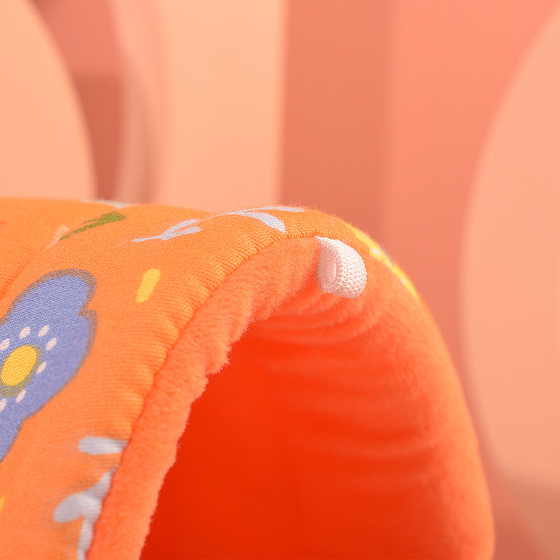 Close-up of an orange fabric with floral patterns on a soft focus background