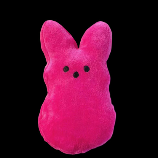 Pink plush toy with black eyes on a light gray background