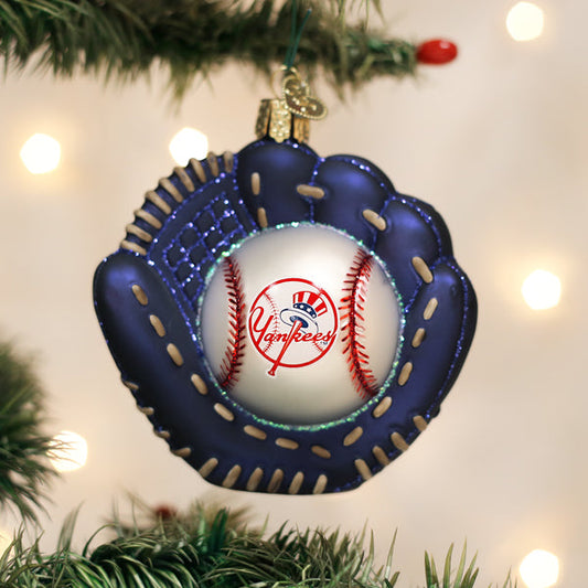 Baseball glove ornament with a baseball inside, featuring the Yankees logo, hanging on a Christmas tree.