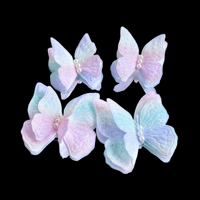Pastel-colored butterfly-shaped earrings on a decorative plate.