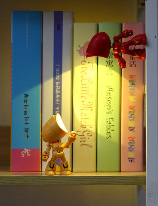 Toy figure standing next to books on a shelf