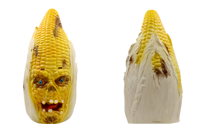 Corn sculpture with a face on a white background
