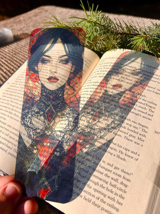 Artistic bookmark with a stylized illustration of a woman held over an open book.