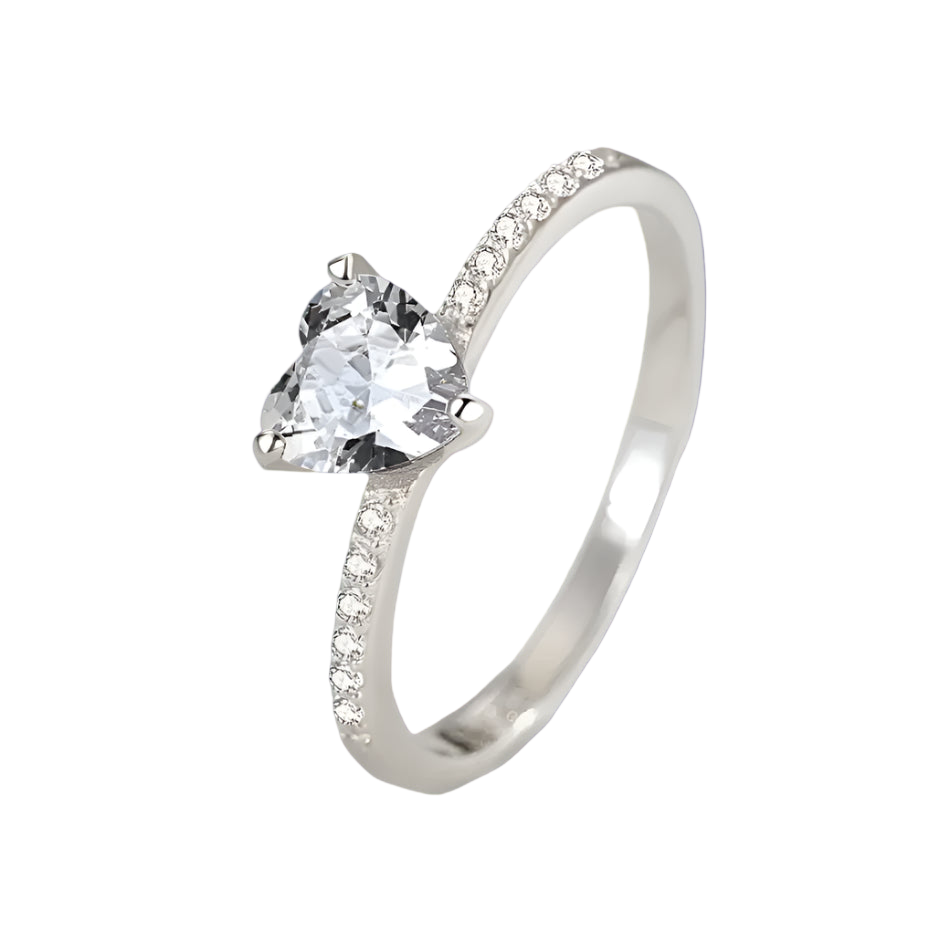 Silver ring with a heart-shaped diamond on a light gray background