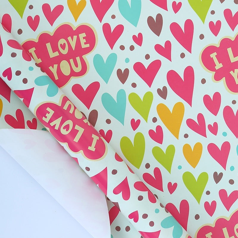 Colorful heart patterned paper with 'I LOVE YOU' text on a white background