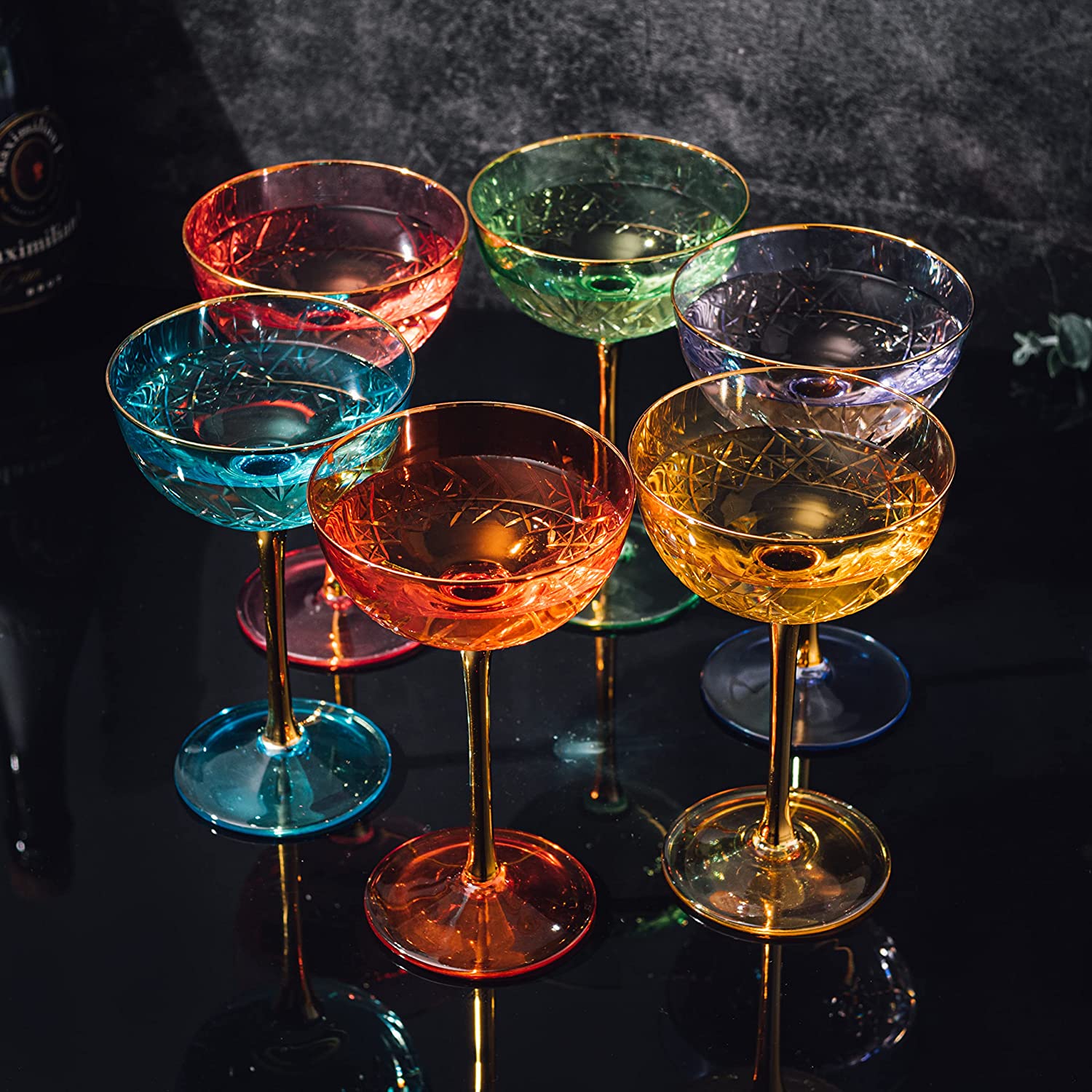 Set of colorful cocktail glasses on a dark surface