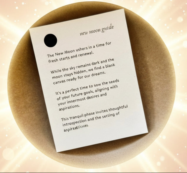 New moon guide card on a textured surface