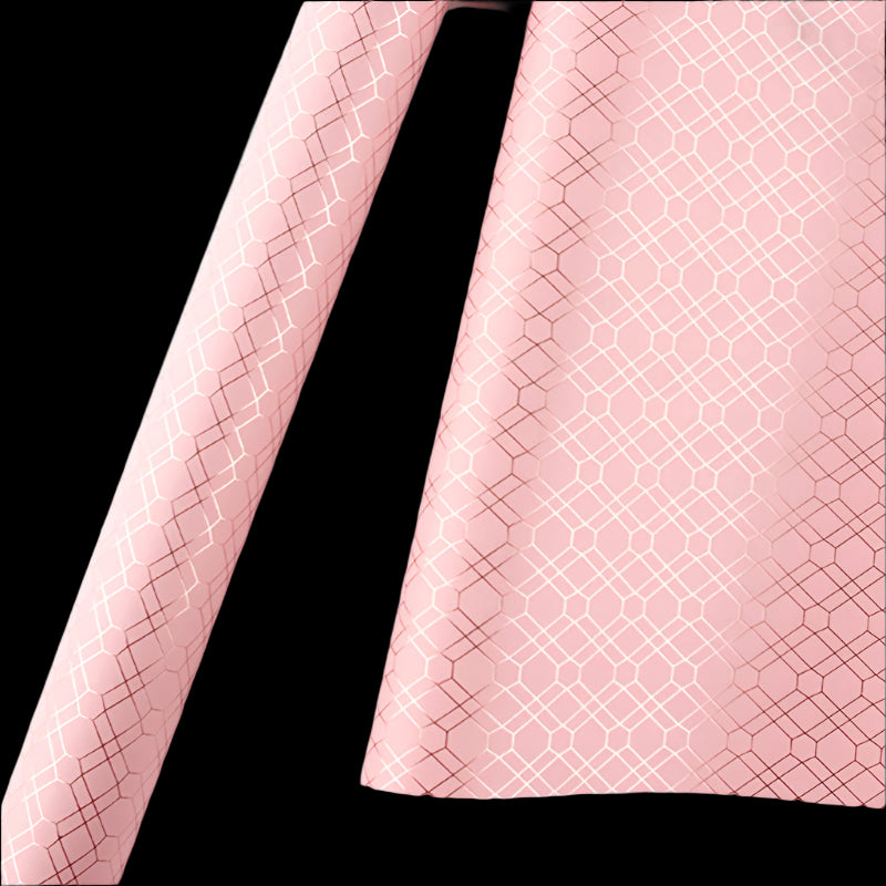Pink fabric with a geometric pattern on a white background